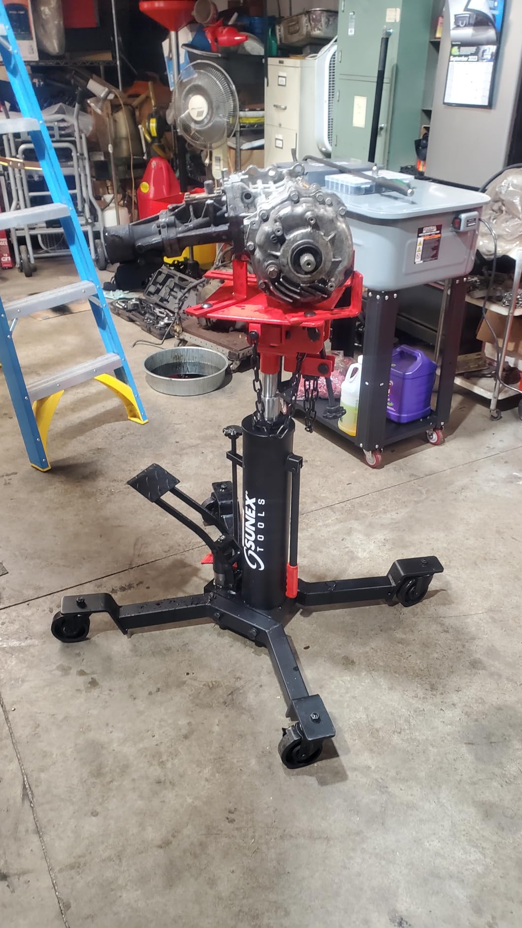 Sunex Tools 7793B 1,000 lb Telescopic Transmission Jack, Hydraulic, Foot Pump Operated, Tilt Saddle with Chain Tie-Down, 74.2 in Max Height customer photo 2