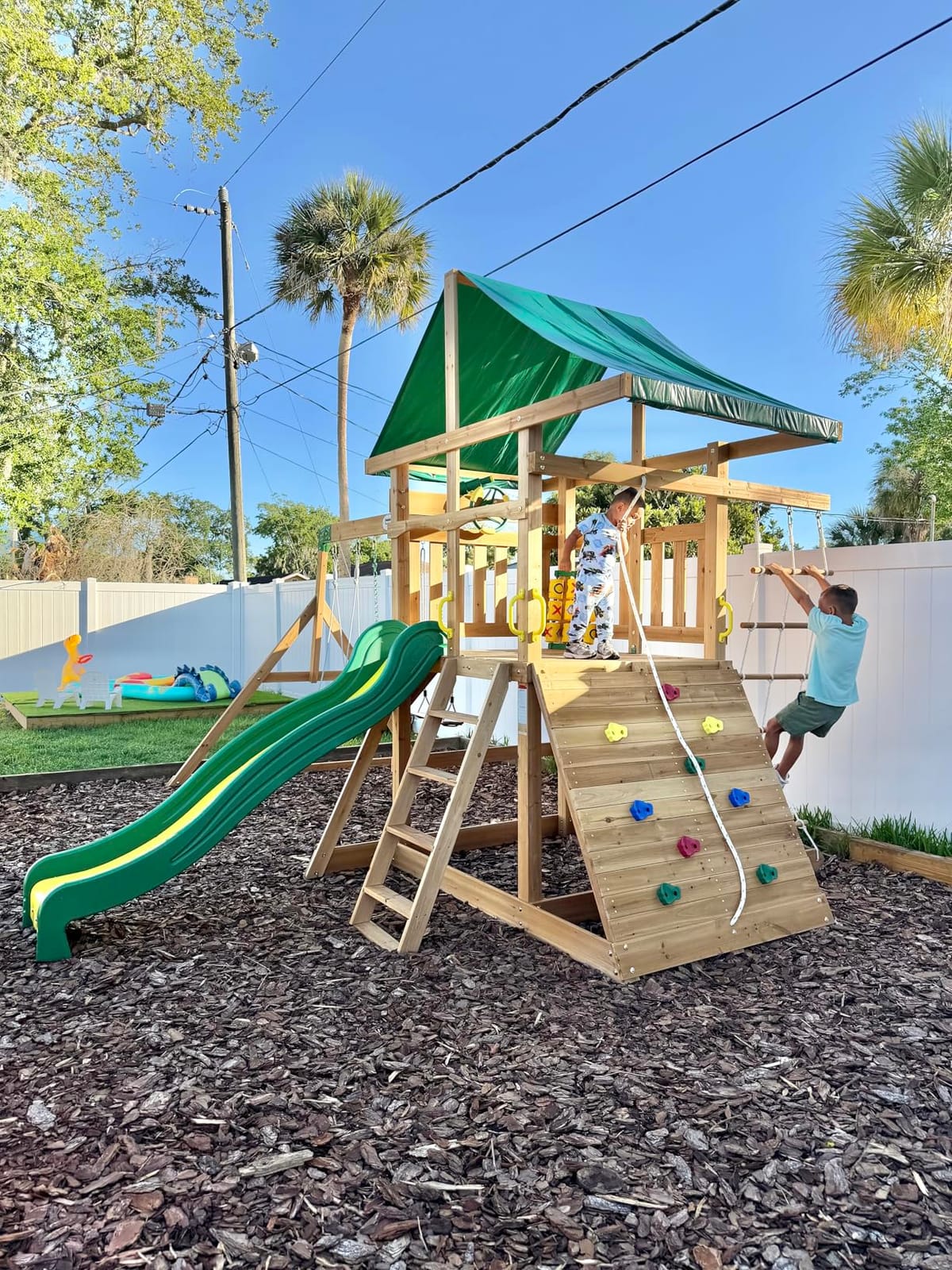 Backyard Discovery Mount Mckinley Cedar Wood Swing Set with Wave Slide, Play Deck, Double Rock Wall, Rope Ladder, Web Swing, Belt Swings, Toy Telescope, Steering Wheel, Sandbox Area, Outdoor Playset customer photo 2